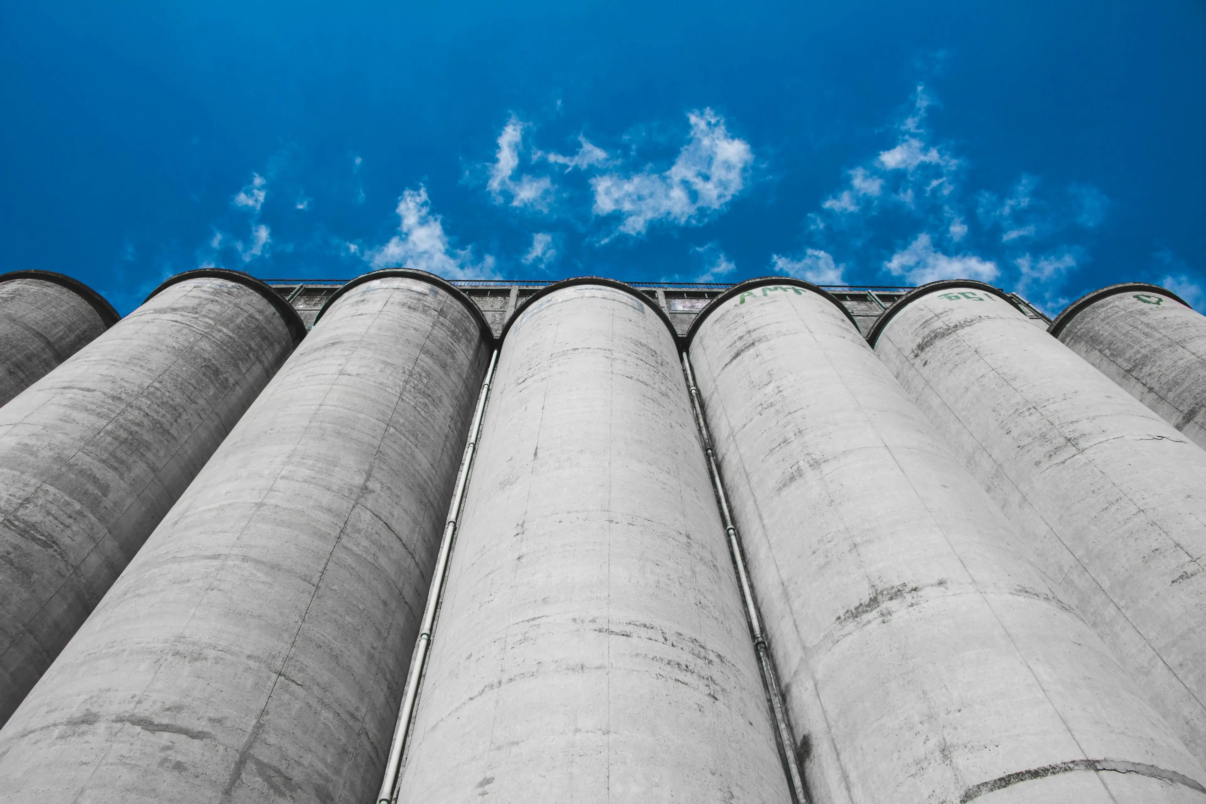 Row of cement silos viewed from below