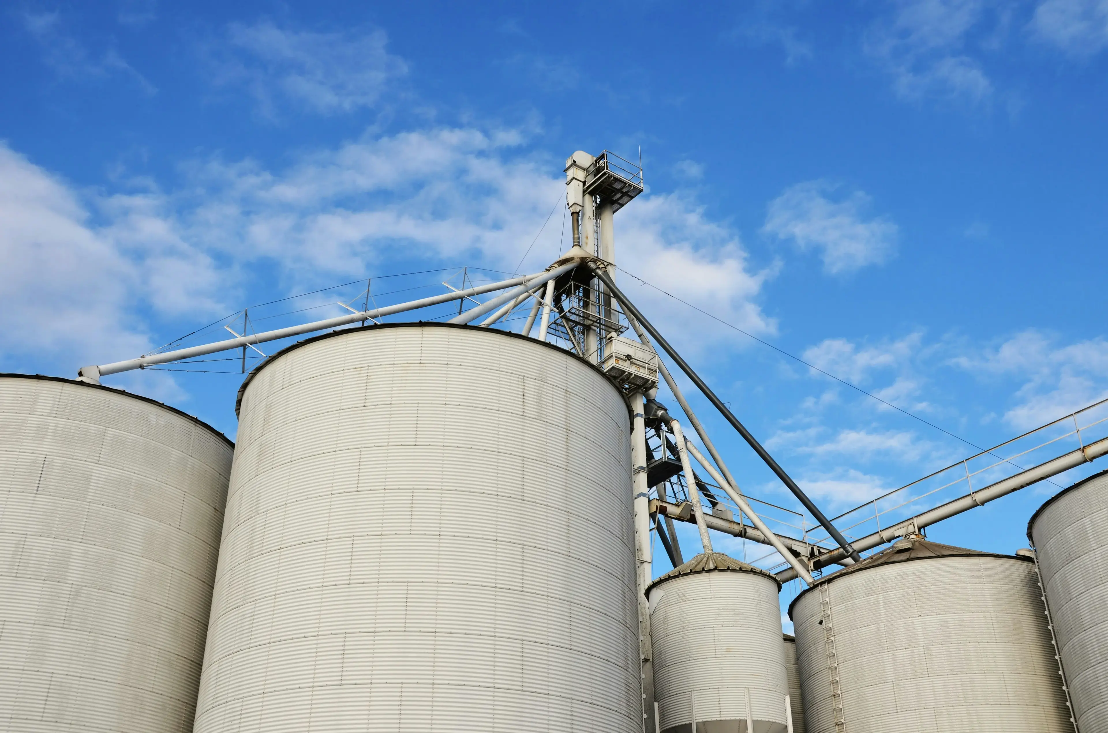 Storage silos with a conveyor tower at a materials plant